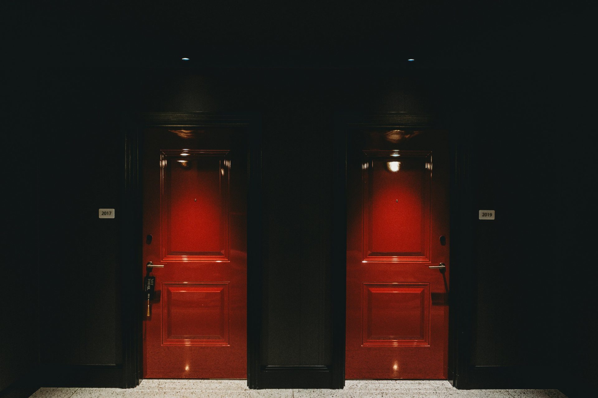 a couple of red doors in a black room
